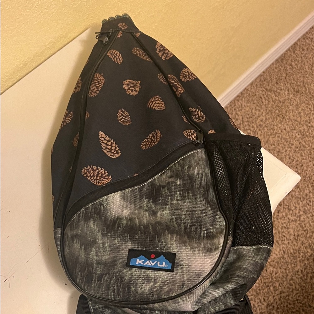 Kavu Pine Cone Print Sling Backpack in Black and Brown